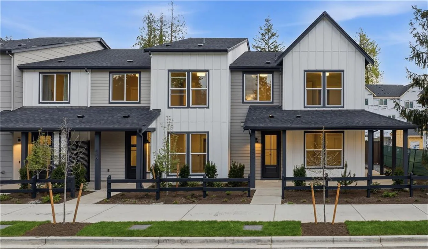 Contemporary Parkside Sammamish homes with white and gray siding along a landscaped street.