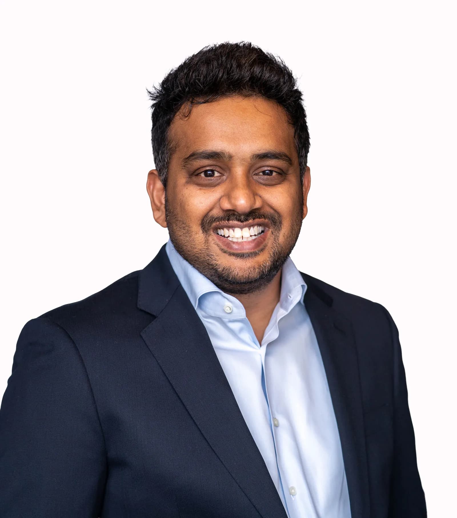 Portrait of Aditya Kasturi in a navy blazer and light blue shirt.